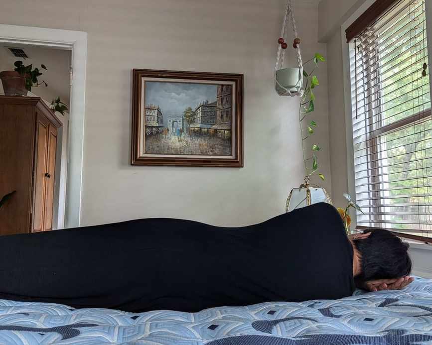 A woman lying on the blue Stearns & Foster Estate Mattress.
