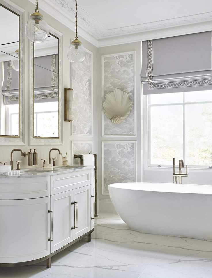 A bathroom with subtle wallpaper and marble flooring