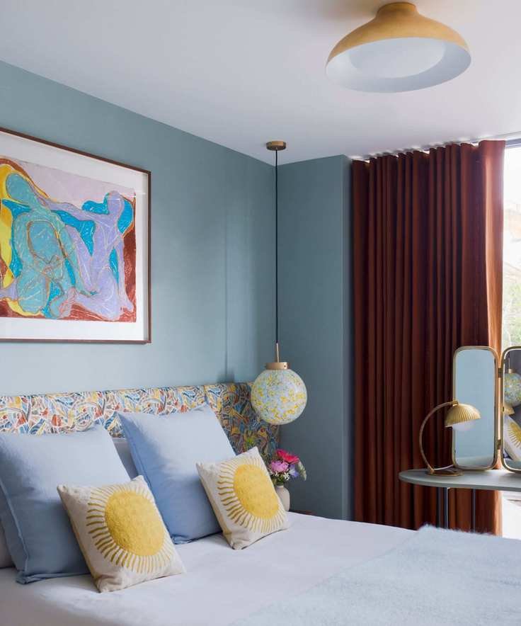 blue bedroom with pops of yellow and retro inspired decor