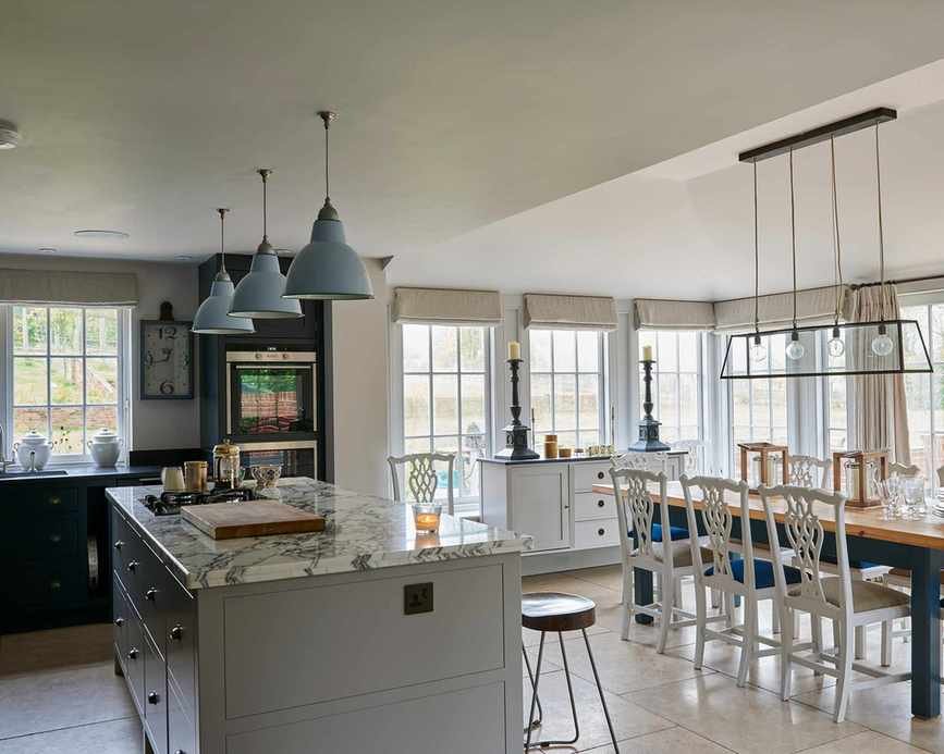 Kitchen remodel ideas shown through a picture of a new kitchen extension with traditional windows and statement lighting