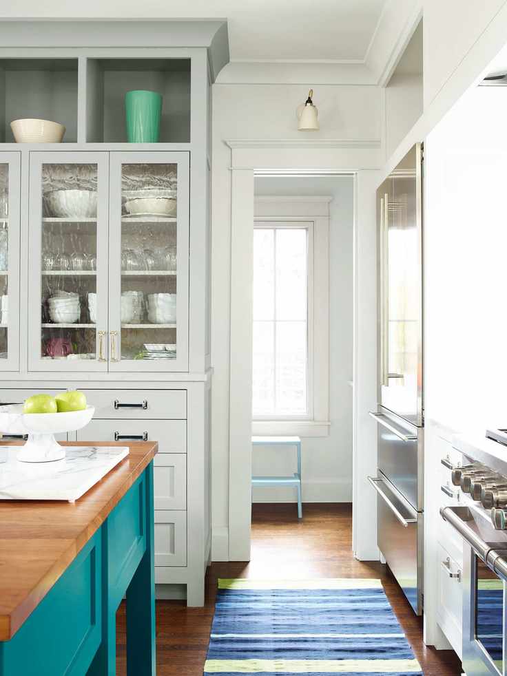 Kitchen cabinets painted with Benjamin Moore gloss paint in vibrant colors.