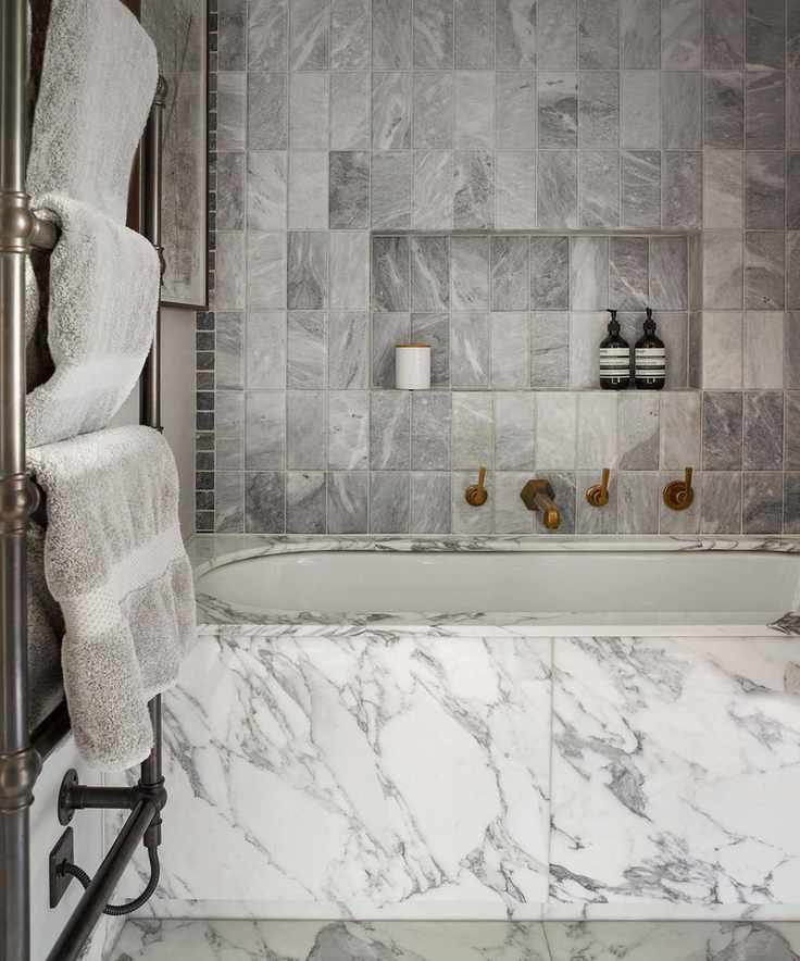 Bathroom with gray marble tiles and a towel rail