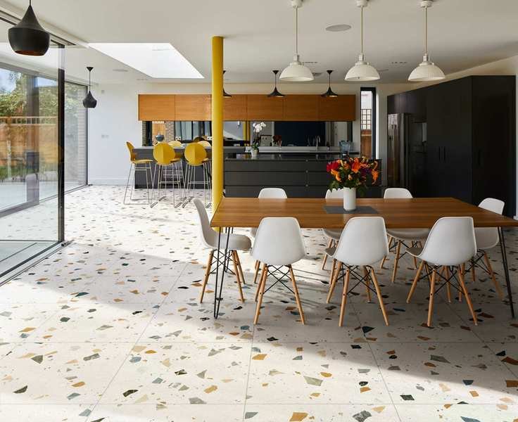 A kitchen with terrazzo kitchen floor tile ideas and warm wooden and black cabinetry