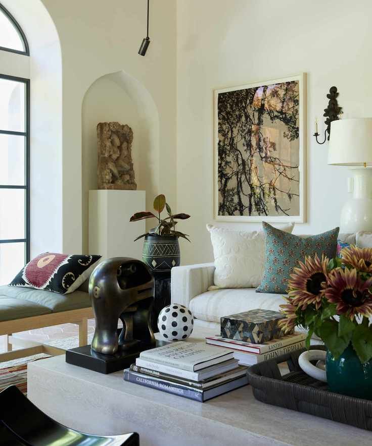 A large coffee table with decorative accessories in a living room