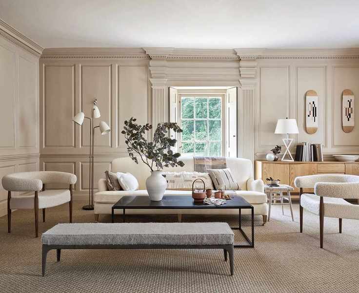Beige living room featuring wall panels and a sleek coffee table.