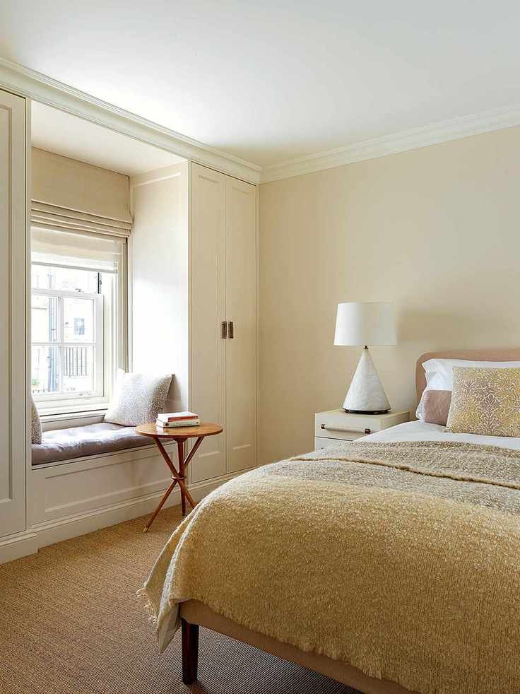 Beige bedroom featuring a cozy window seat