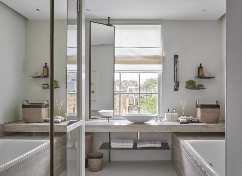 A bathroom with innovative space-saving features, like a vanity in front of a window