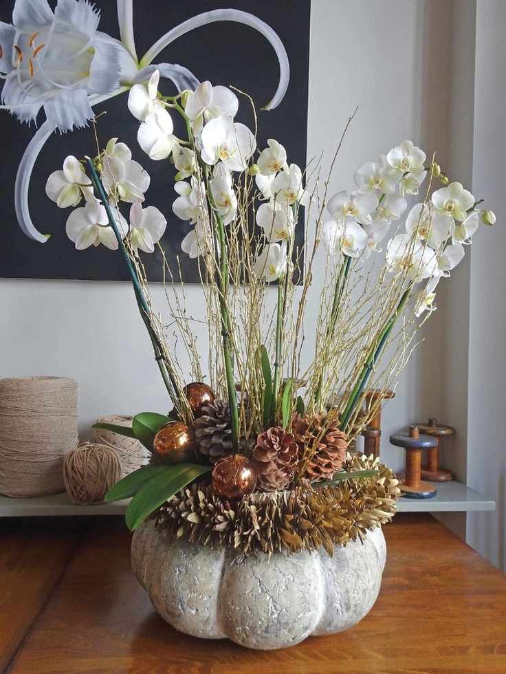 Orchid and pine cone display