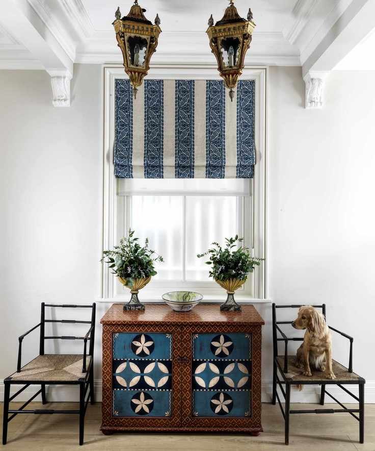 A hallway shoe storage idea with decorative cupboard in K&H Design room