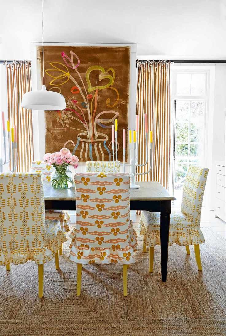 Dining chairs with slip covers in nLadder Leaf linen in Yellow/ Olive and Anna Jeffreys and Chintamani linen in Marigold, both Ottoline at The Fabric Collective
