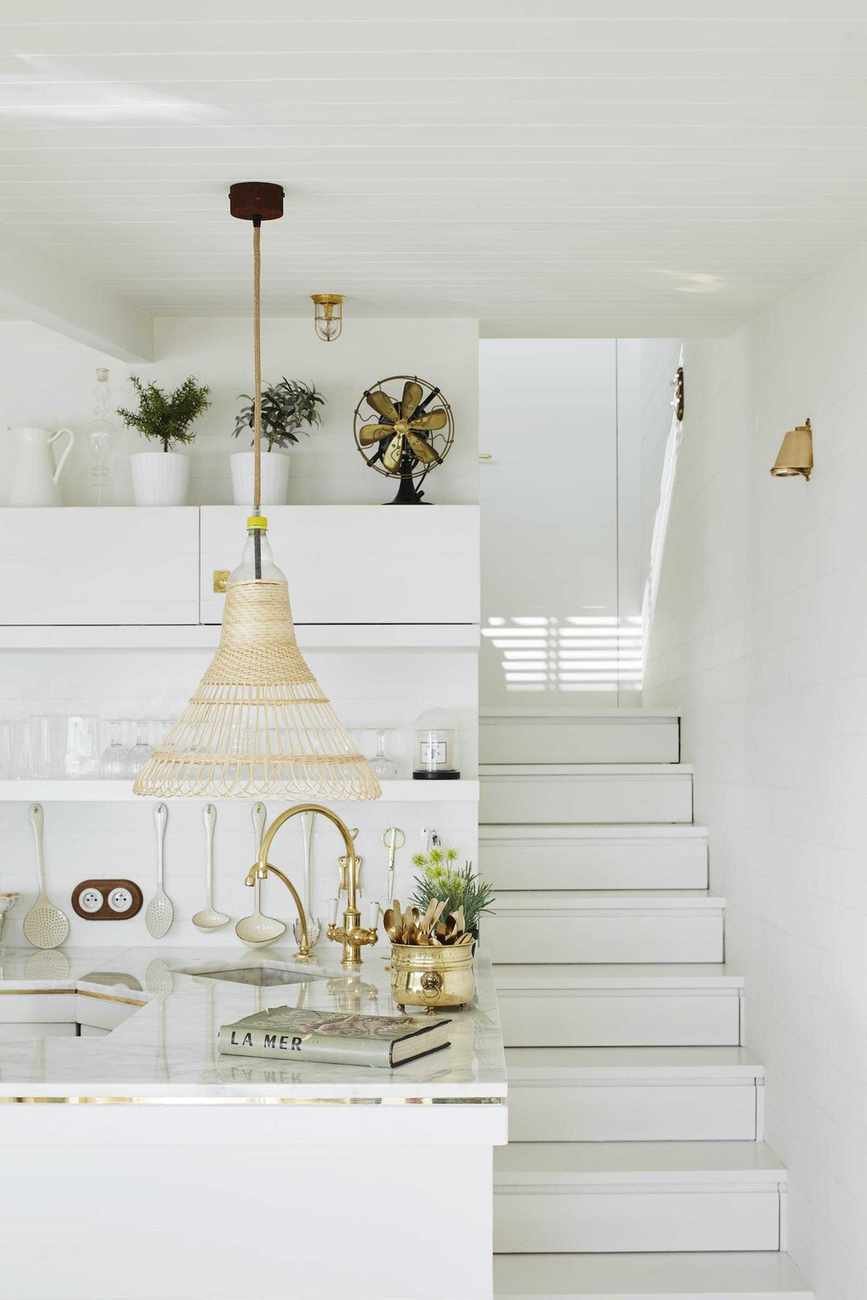 white coastal kitchen with steps and pendant light