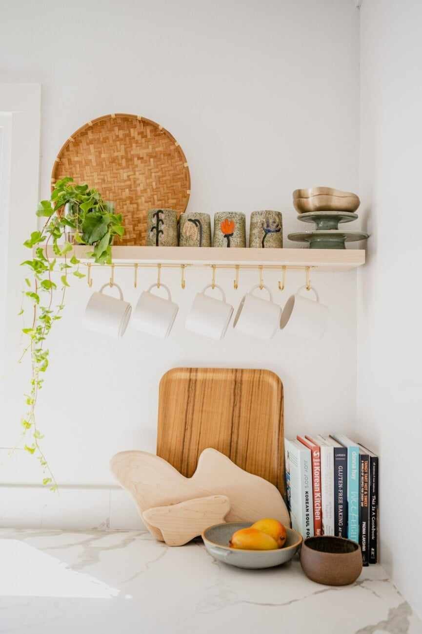 cutting board and plant in white kitchen