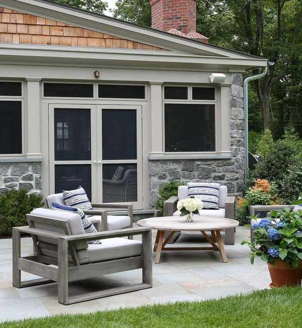 Backyard storage with sunroom and armchairs