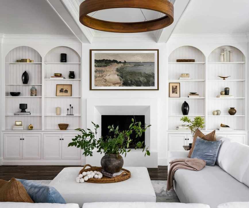 Living room with symmetrical shelving, plants and ambient lighting