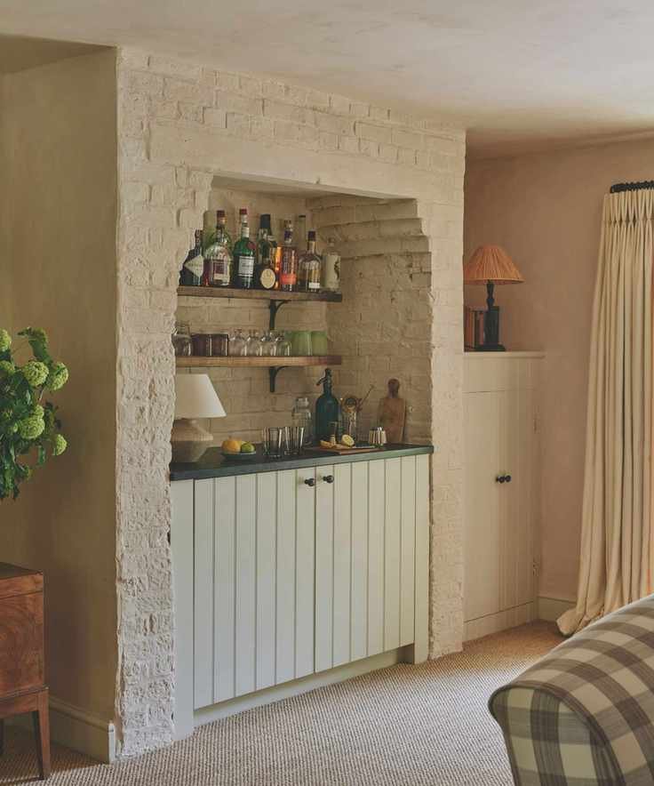 bar inbuilt in repurposed file place nook with painted white brick and open shevles and cabinet