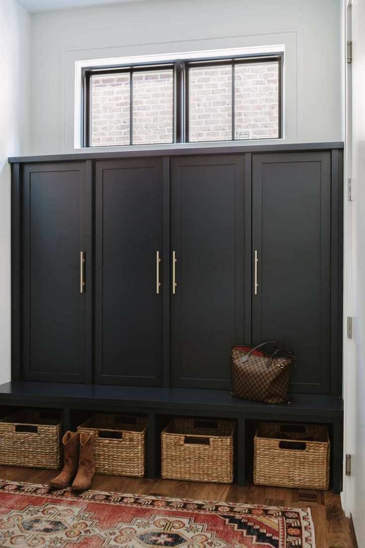 bespoke mud room with painted doors and baskets underneath