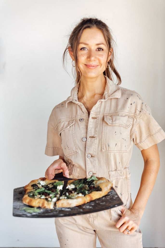Freshly baked spinach ricotta pizza on pizza stone