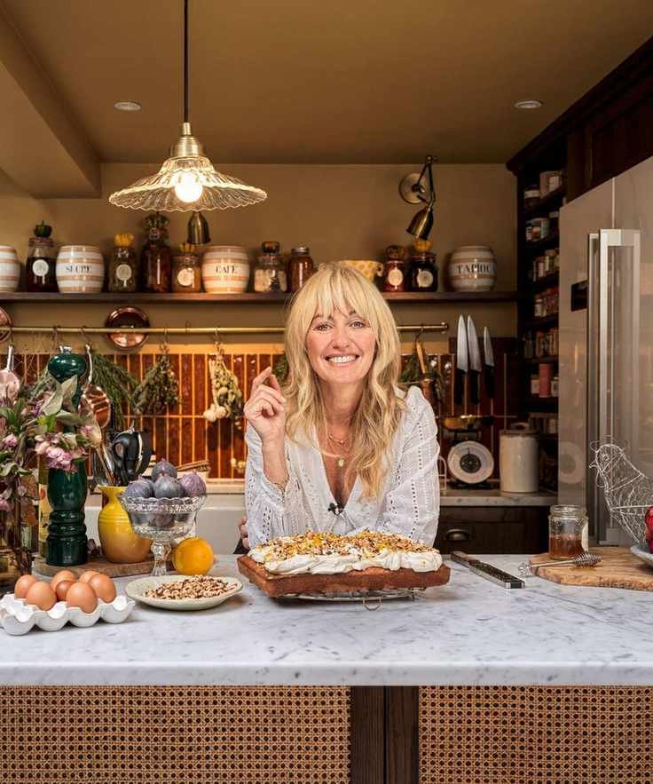 Chef in her kitchen with a cake on the counter