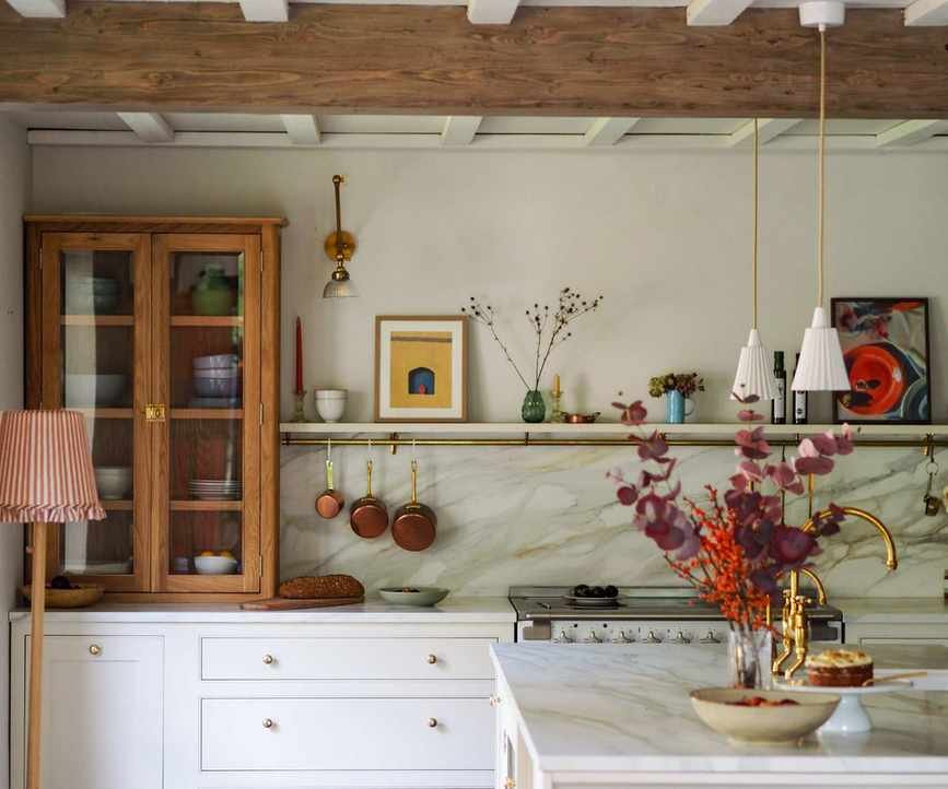 A country kitchen with white and wood cabinets