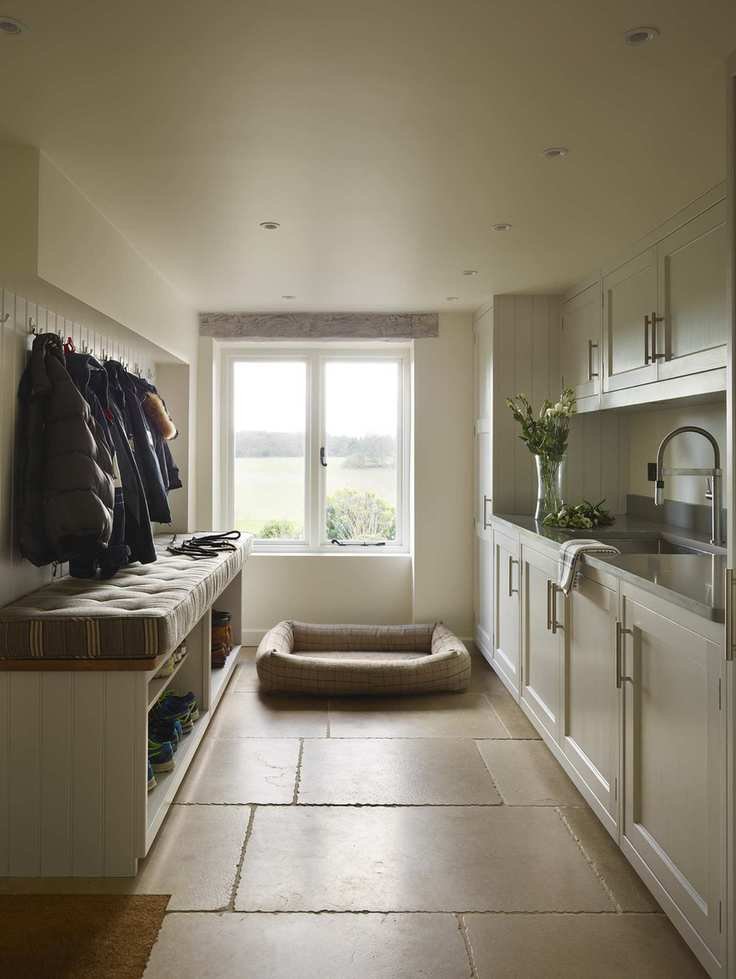 Utility room in neutral shades with a bench and sink