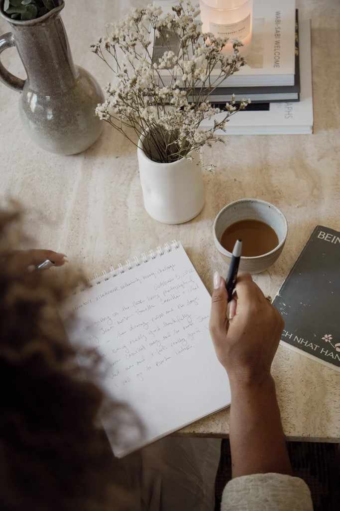 woman journaling at table