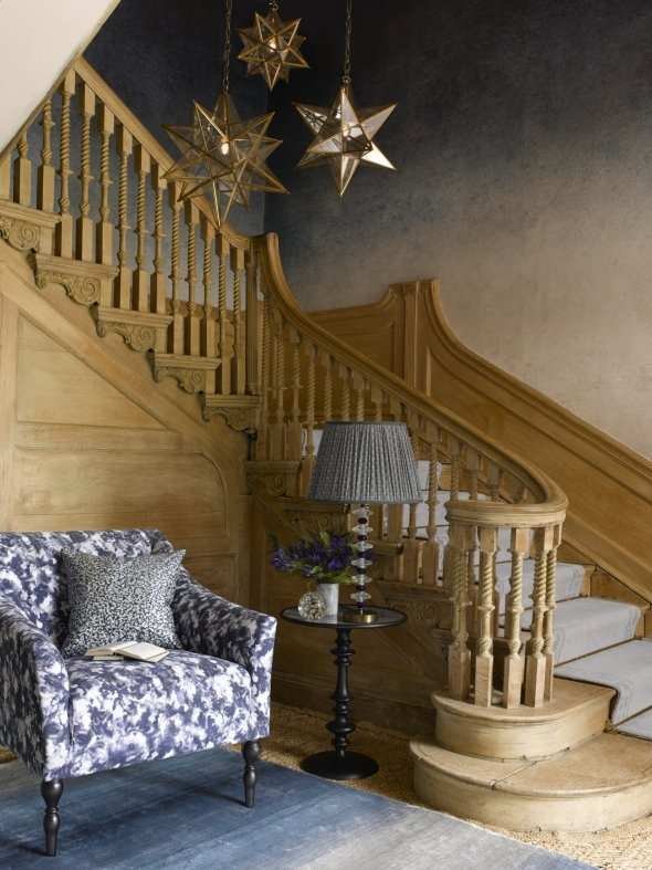 Stylish hallway with blue patterned chair and matching staircase