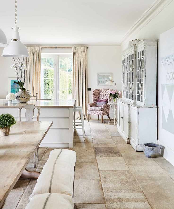 White kitchen with wooden table and bench seating