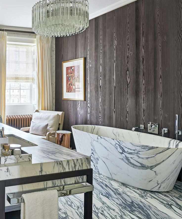 Parisian bathroom with wood panels and marble bathtub