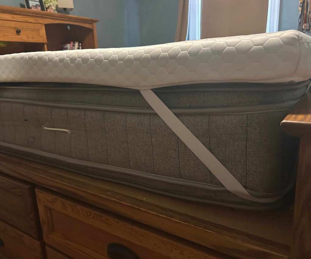 Corner of the Helix ErgoAlign Mattress Topper on a bed.