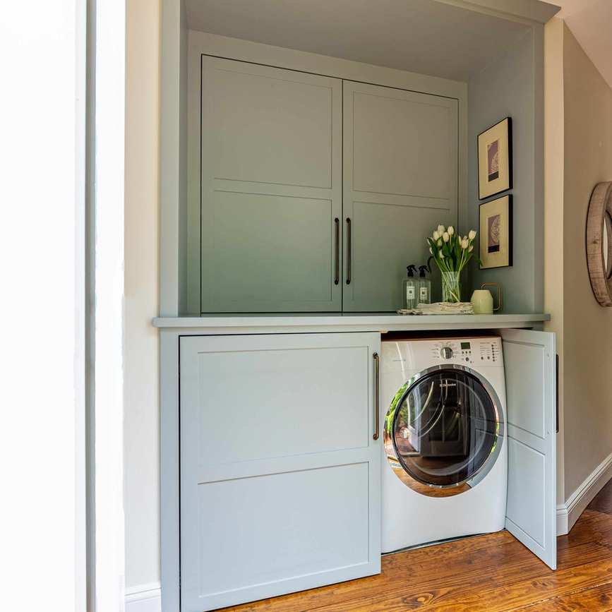 Washer and dryer hidden behind cabinet doors.