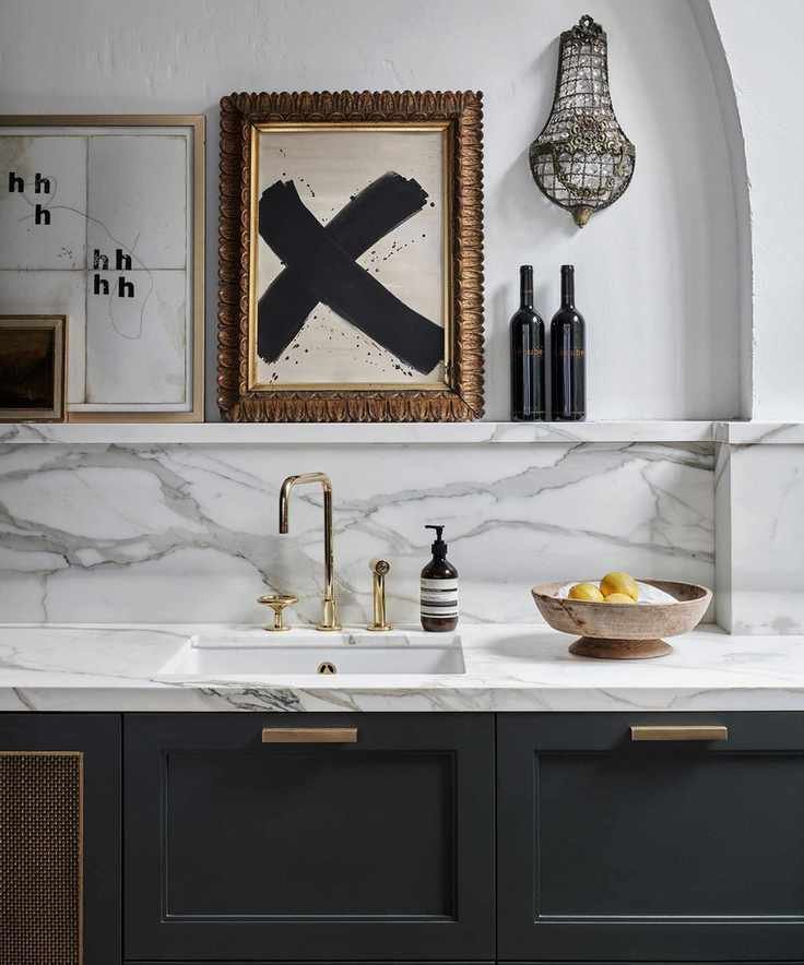 Transitional kitchen with brass handles and accents