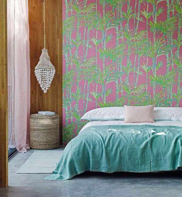 A colorful bedroom with a patterned statement wall and stylish decor