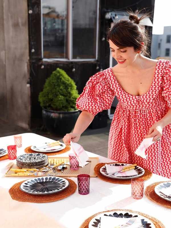 woman setting the table on a NYC rooftop