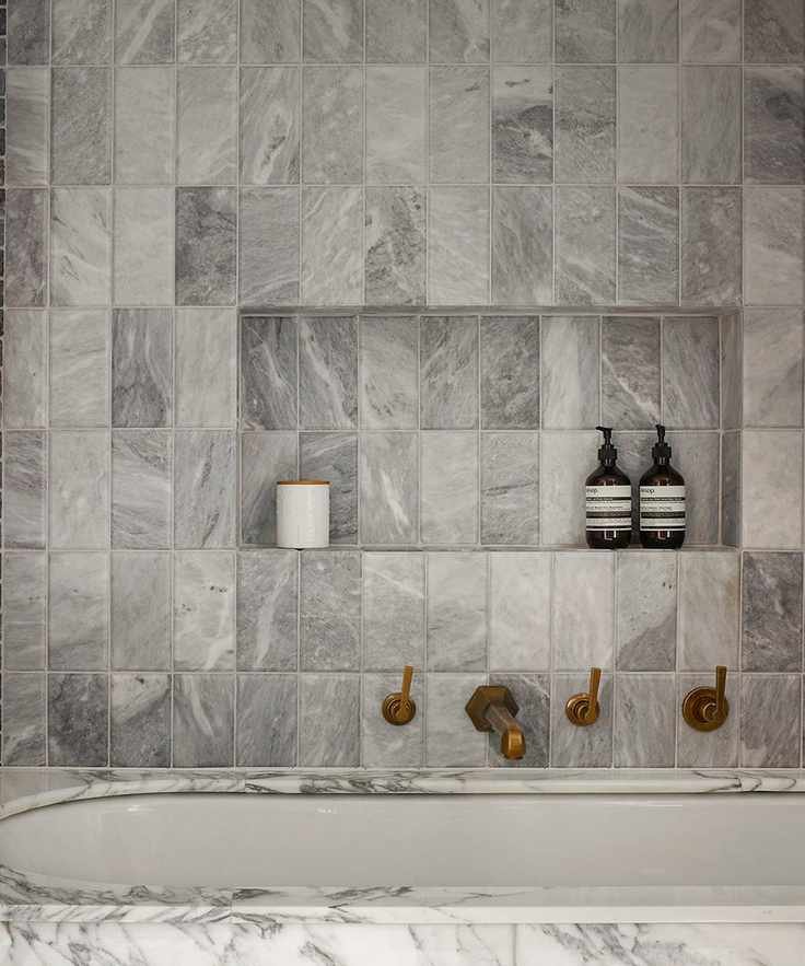 bathroom with tub and tiles