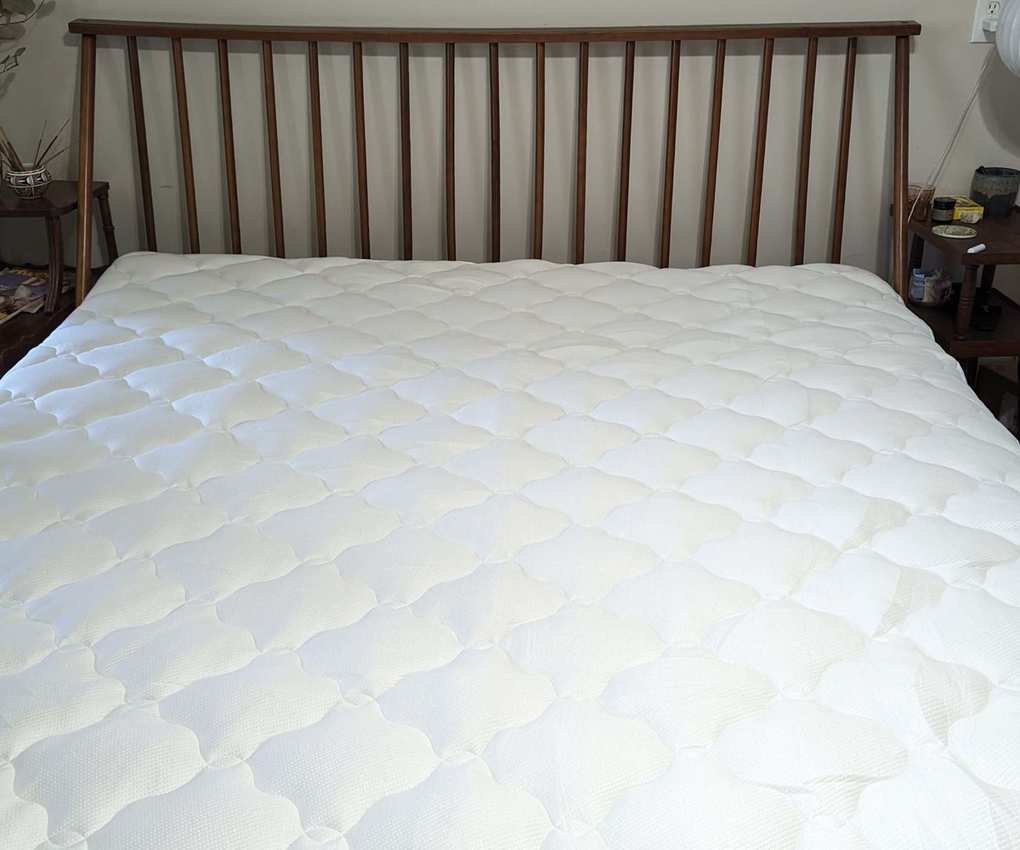 Helix Plush Mattress Topper on a bed.