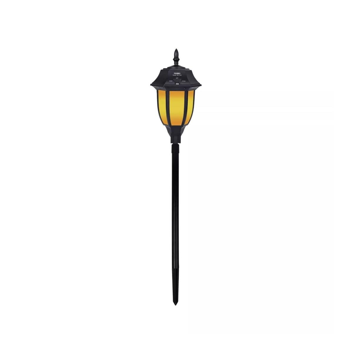 A black outdoor wireless light with an amber light and a base with a spike at the bottom