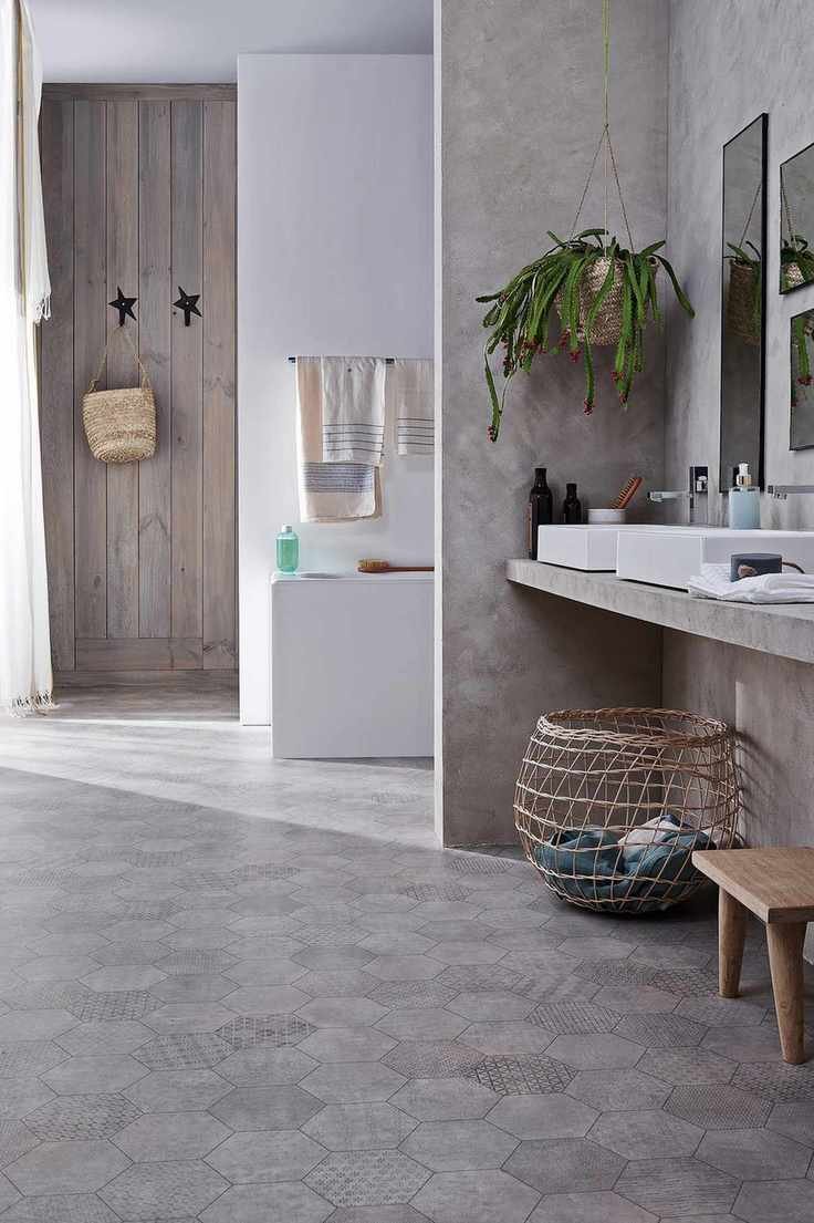 neutral bathroom with vinyl patterned flooring, double basins, bath in background