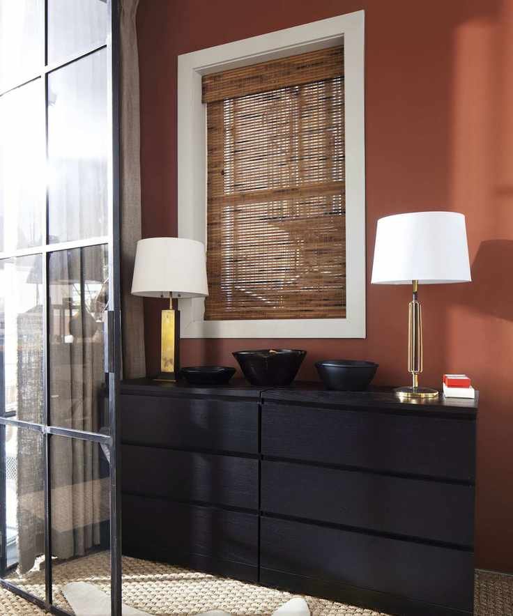 hallway decorated in warm orange with a dark wood console table
