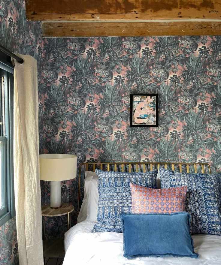 Farmhouse style bedroom with blue and pink wallpaper and decor