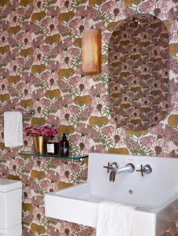 A powder room with floral wallpaper