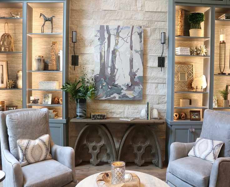 living room with artwork on wall and bookcases