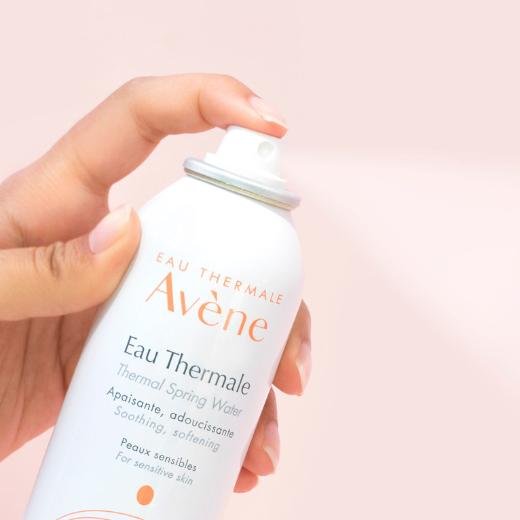 Hand model with a bottle of Avene Eau Thermale