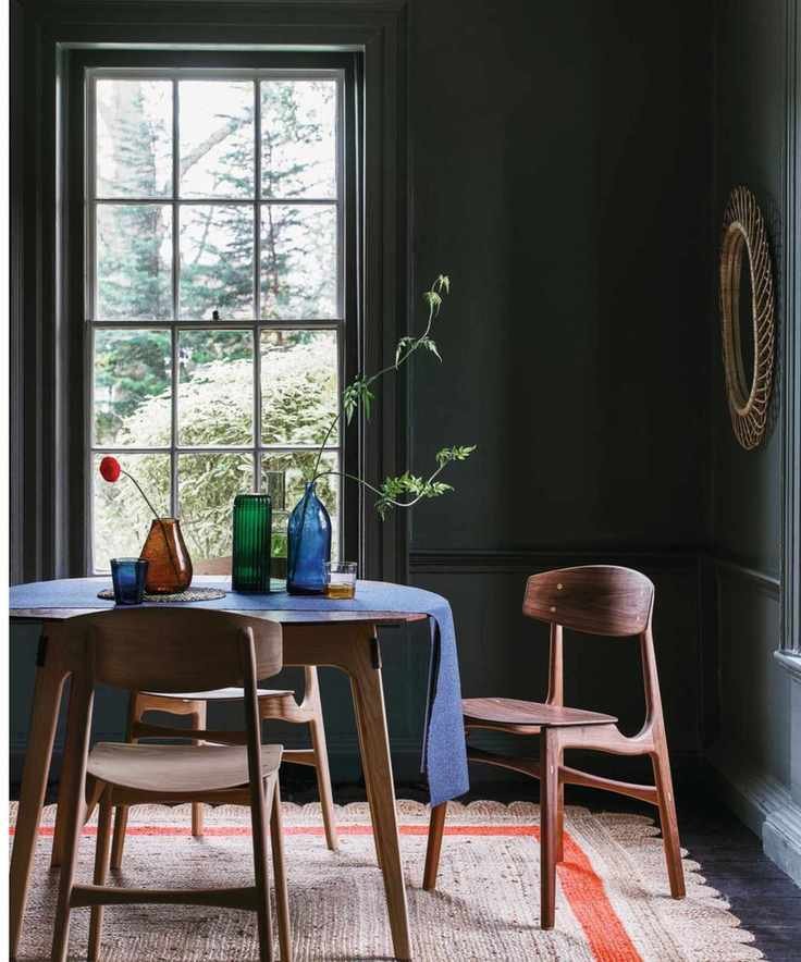 Dining room with black walls and large window