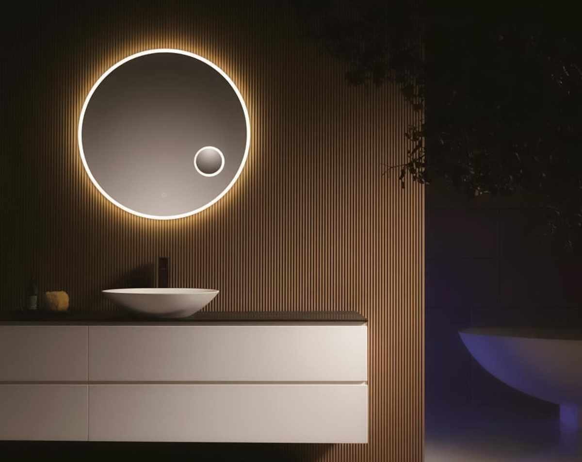 Round illuminated bathroom mirror and vanity