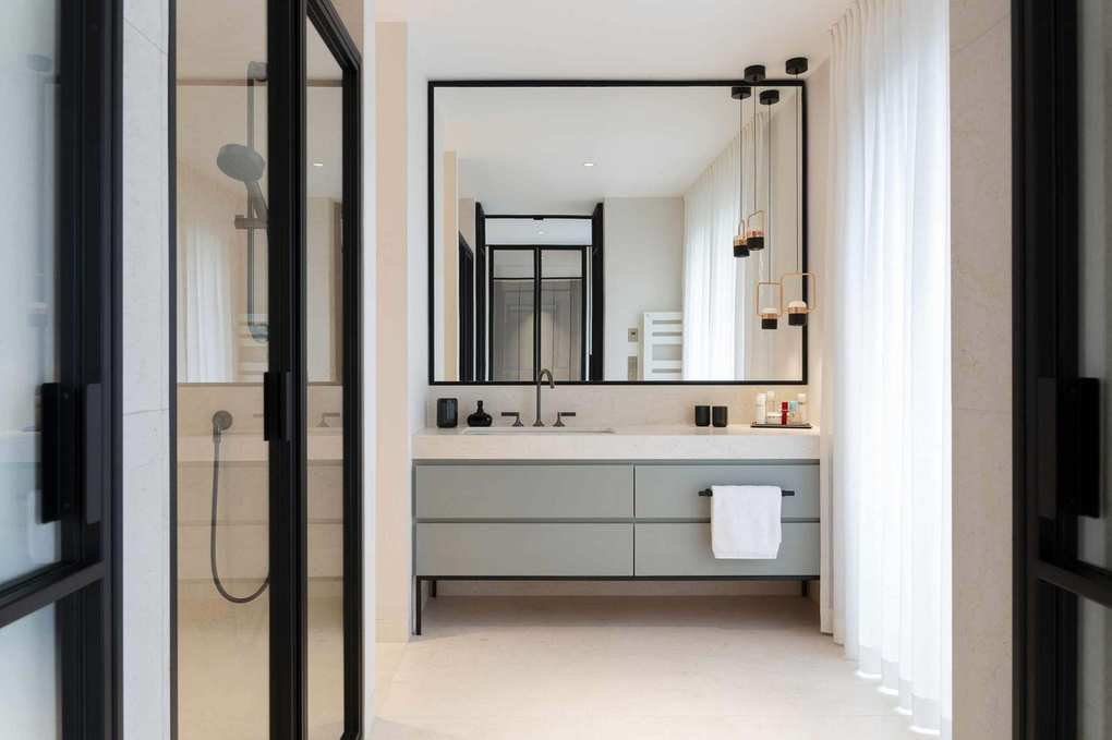 A bathroom featuring a large mirror above a vanity