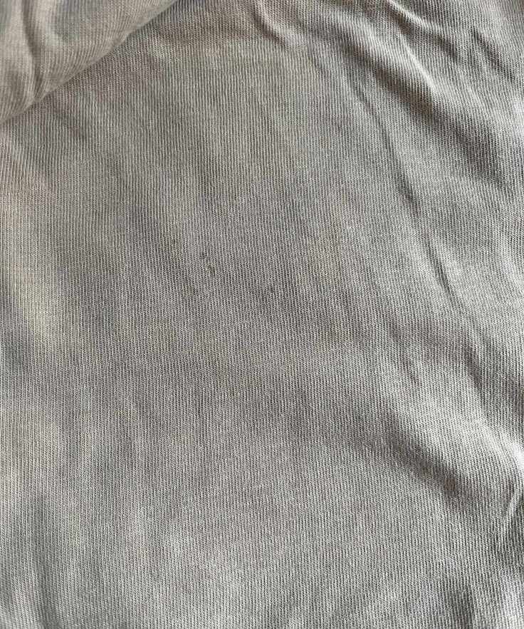 Some old, small blood stains on a beige top