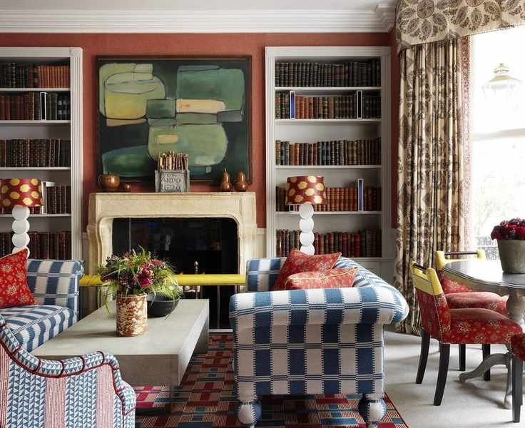 A cozy living room with orange walls and stylish sofas