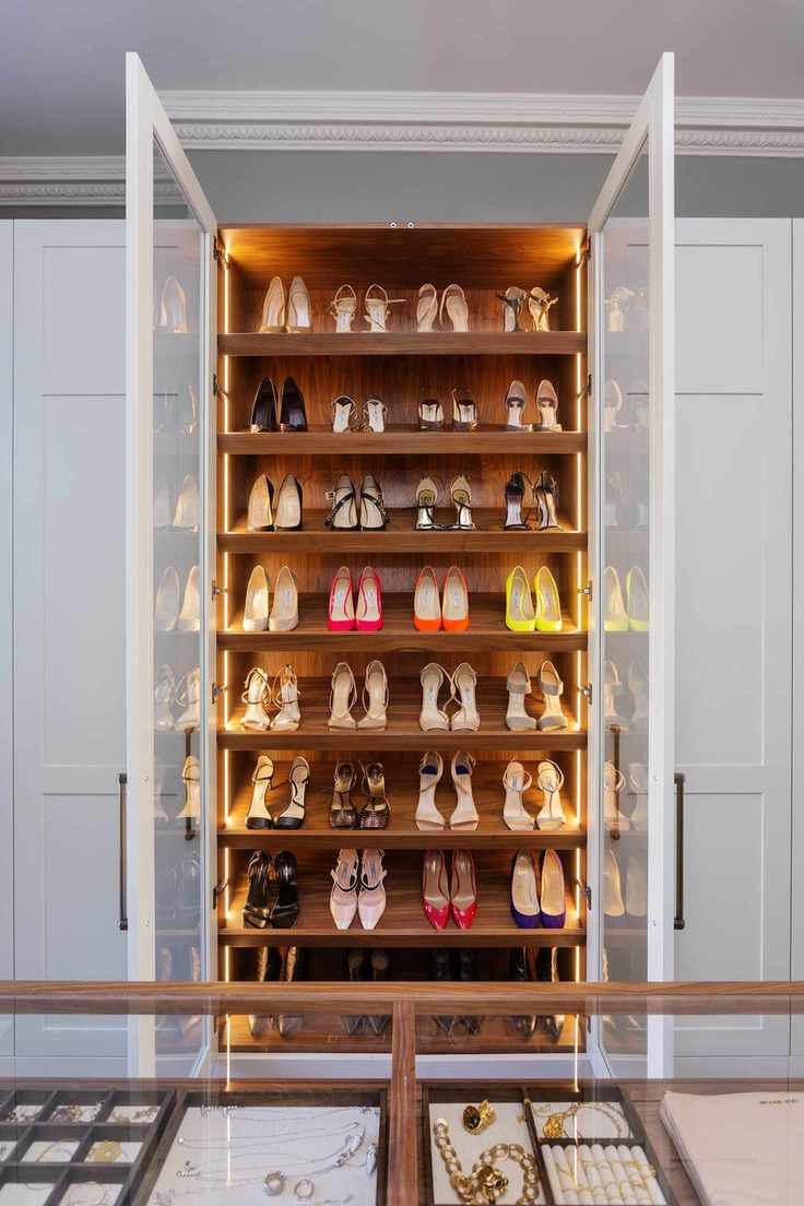 closet shoe storage with glass doors, LED lighting, white closet doors each side, jewellery storage in foreground