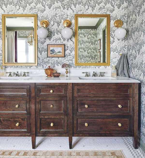 Double vanity bathroom idea with wallpapered wall and gilted mirrors over