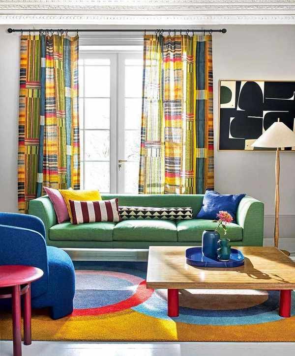 Colorful living room with green sofa and curtains in Pierre Frey's Festival Multicolore fabric